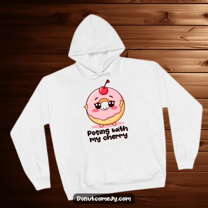Funny hoodie with a proud donut character, topped with a cherry, striking a confident pose, combining humor and cozy style.