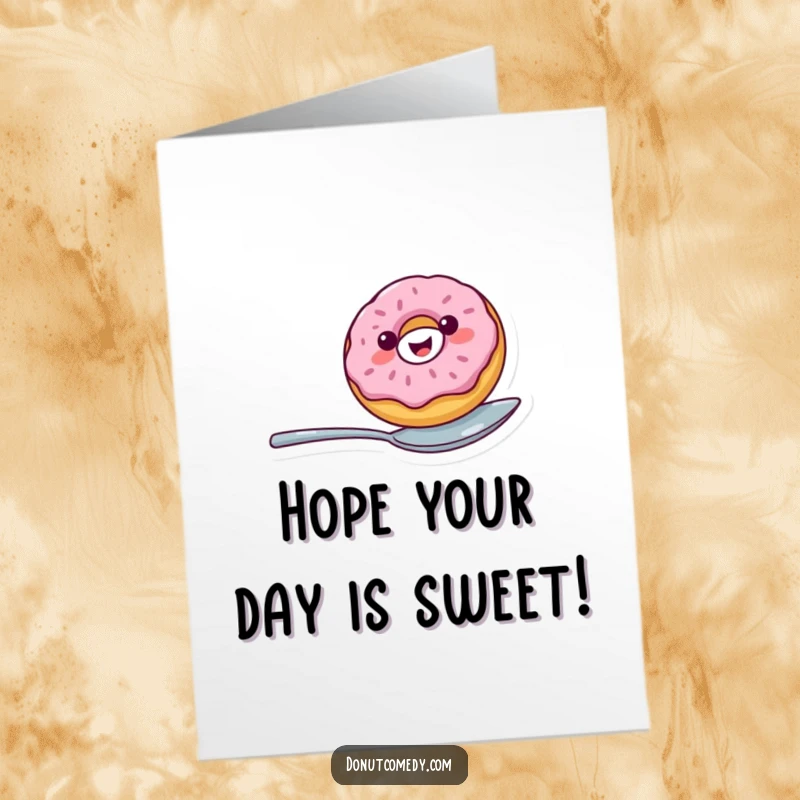 Funny free printable birthday card: cheerful donut character with a big smile, expertly balancing on a spoon, celebrating joyfully.