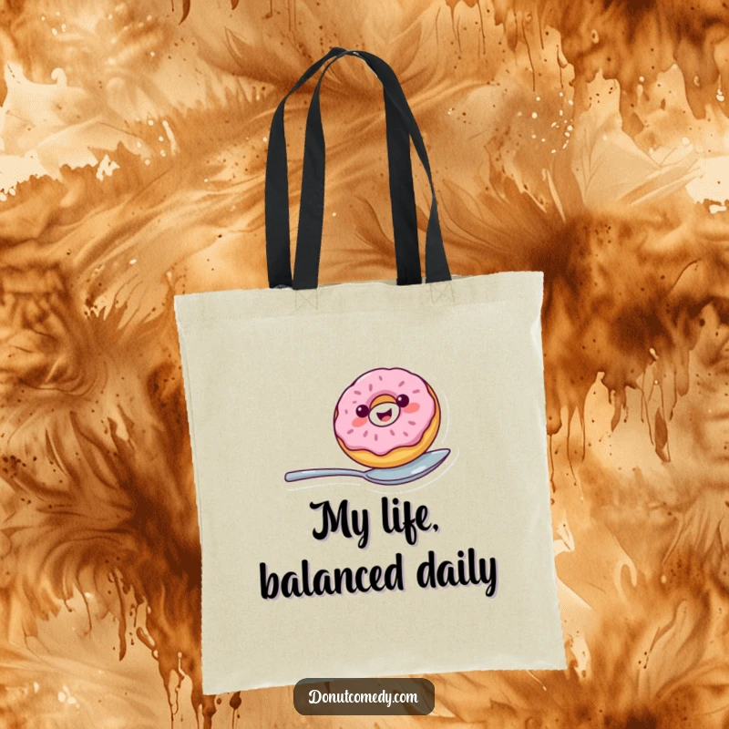 Funny tote bag featuring a cheerful donut character balancing on a spoon, perfect for carrying items with a dose of playful humor.